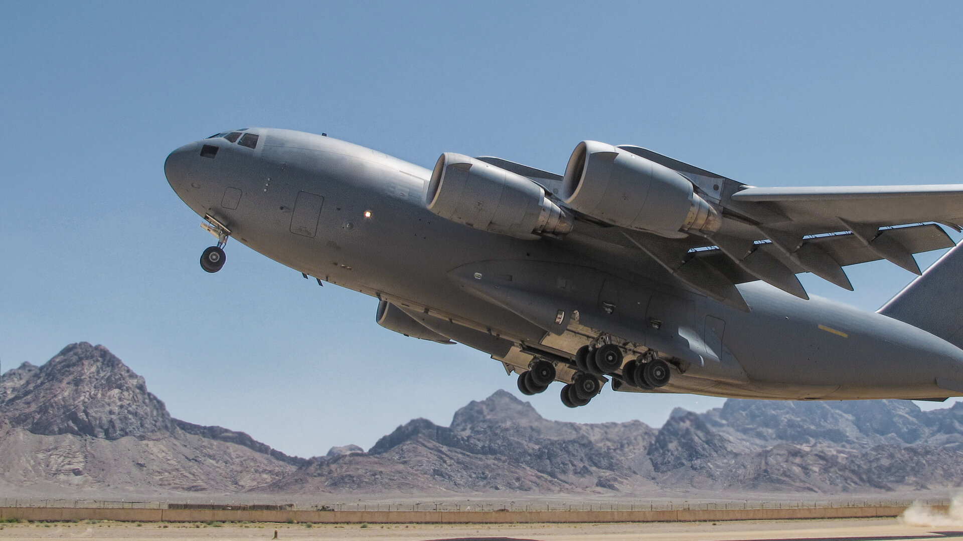 globemaster taking off on dry lake bed