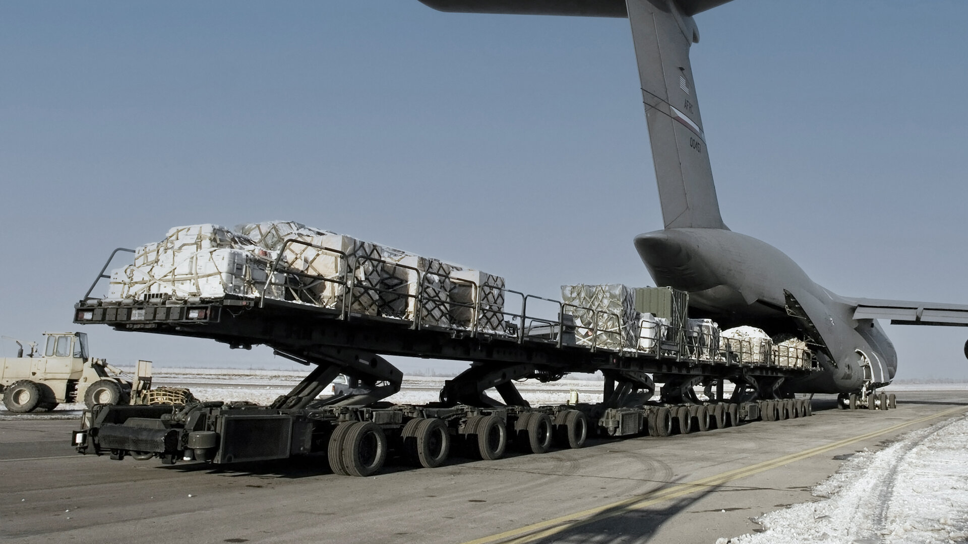 military transport jet loading cargo