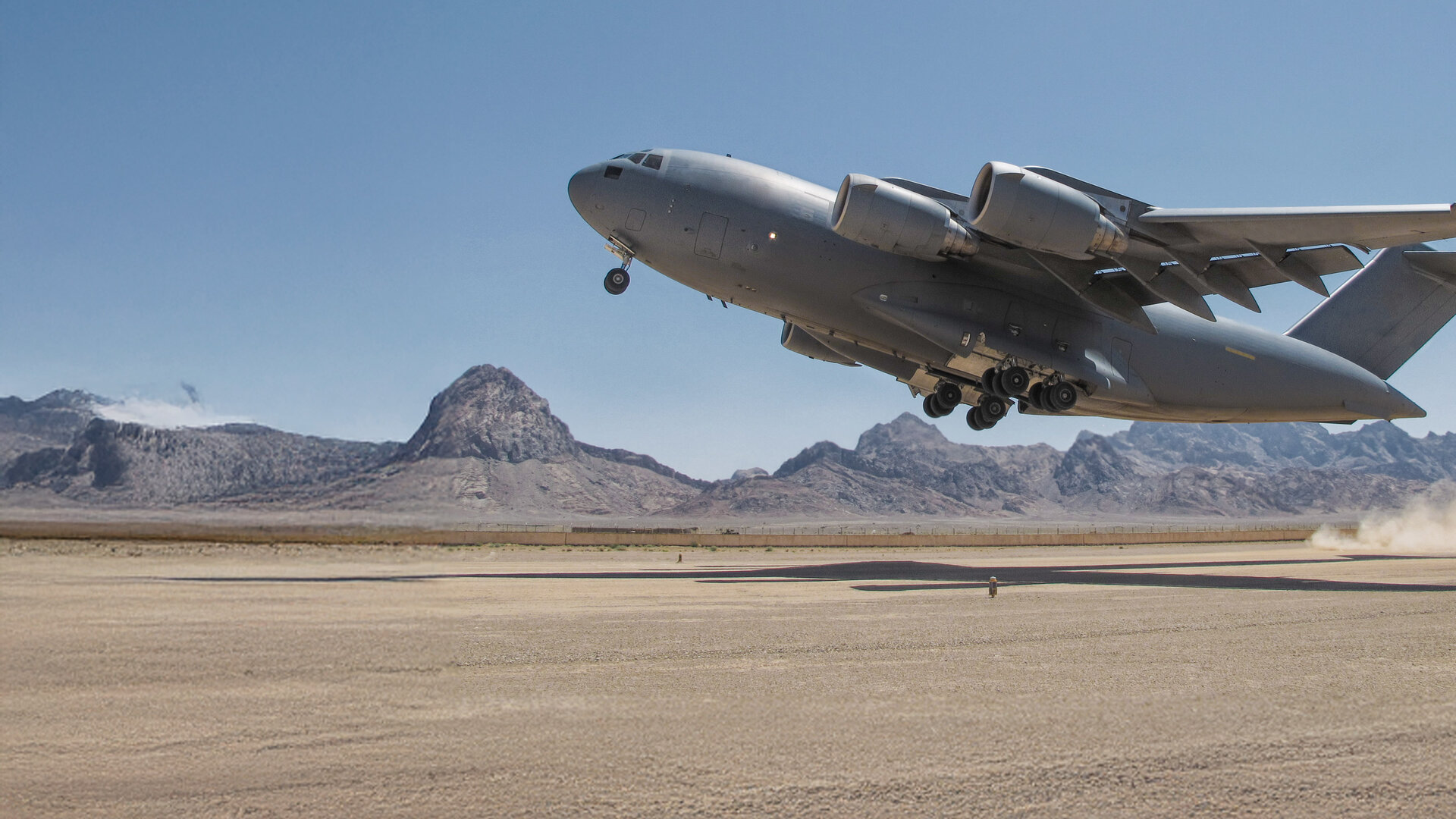 globemaster taking off on dry lake bed