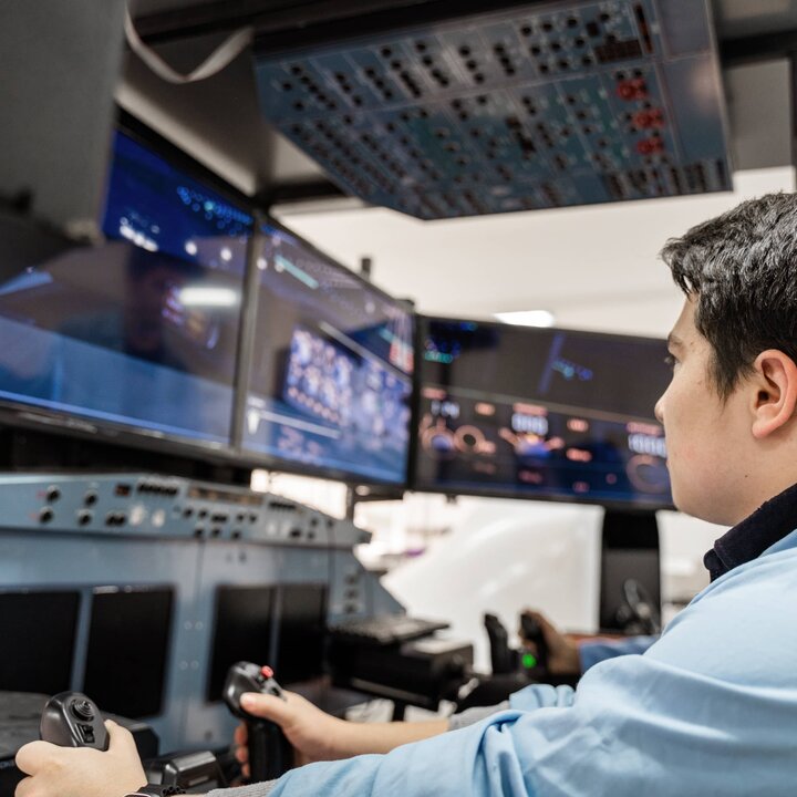 man working on a terminal with joysticks