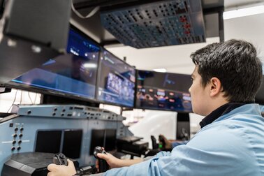 man working on a terminal with joysticks